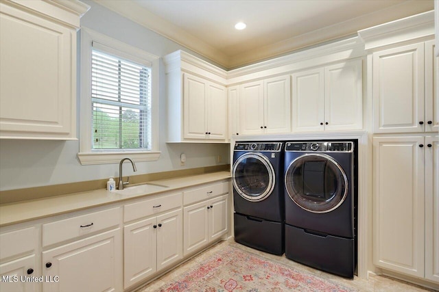 laundry area featuring recessed lighting, independent washer and dryer, a sink, and cabinet space