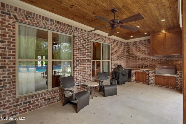 view of patio with grilling area and a ceiling fan