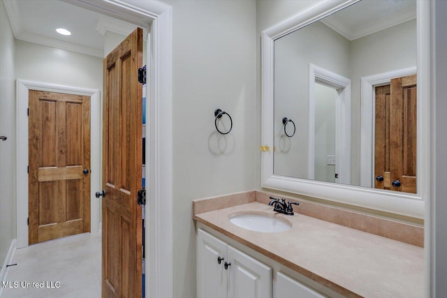 bathroom featuring ornamental molding, recessed lighting, and vanity