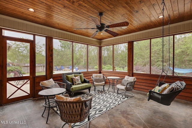 sunroom / solarium with an outdoor living space, a ceiling fan, and plenty of natural light
