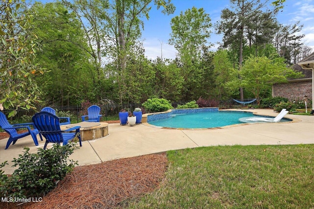 outdoor pool with fence and a patio