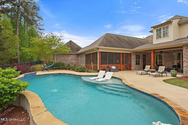 view of swimming pool with fence, a patio, a sunroom, and a fenced in pool