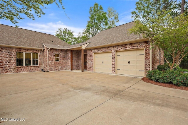 view of front of house with concrete driveway, roof with shingles, brick siding, and an attached garage