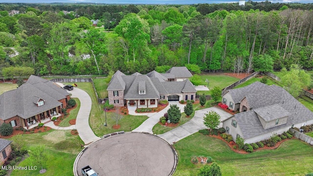 birds eye view of property featuring a view of trees