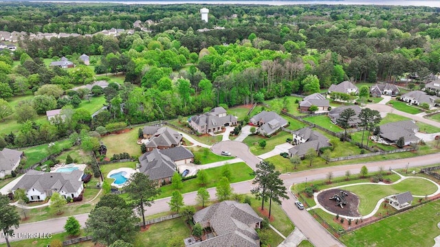 drone / aerial view with a view of trees and a residential view