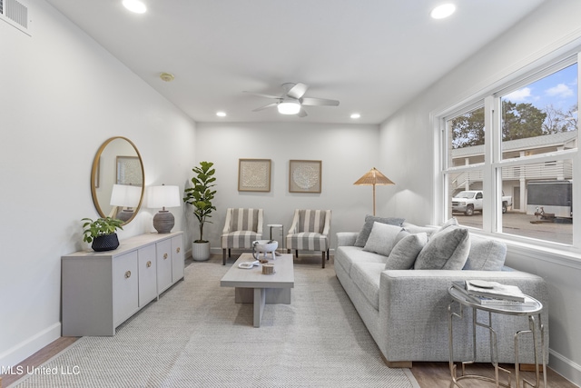 living room featuring ceiling fan and light hardwood / wood-style floors