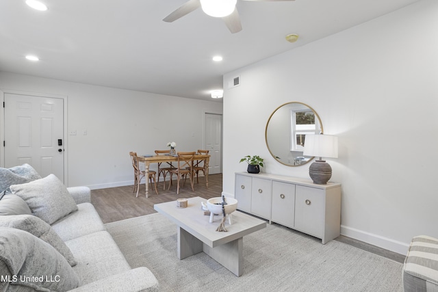 living room featuring ceiling fan and light wood-type flooring