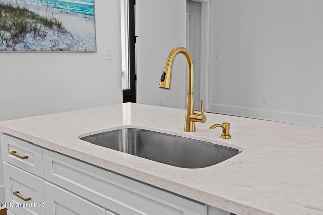 details featuring sink and white cabinetry