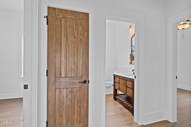 bathroom with vanity, hardwood / wood-style floors, and toilet