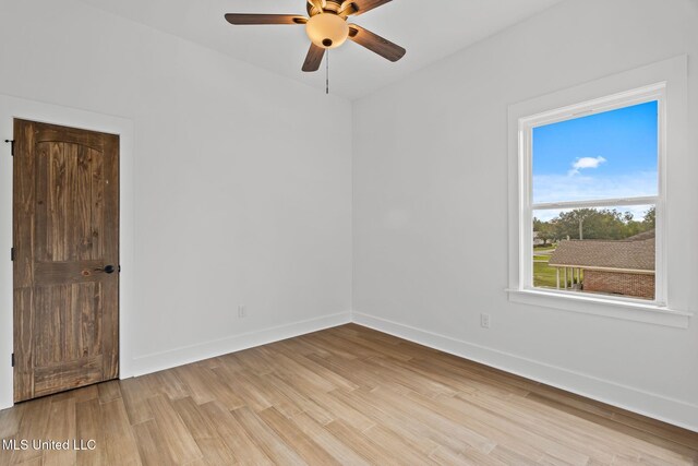 spare room featuring light wood-type flooring and ceiling fan