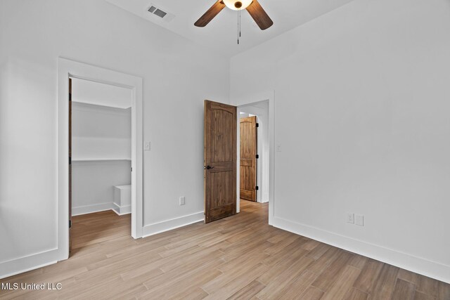 unfurnished bedroom with a closet, ceiling fan, and light hardwood / wood-style flooring