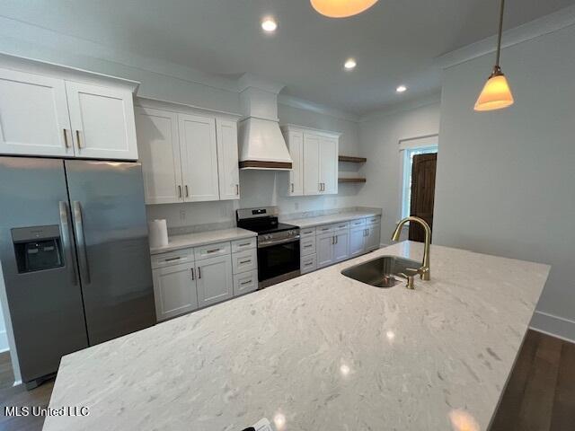 kitchen featuring appliances with stainless steel finishes, sink, pendant lighting, white cabinets, and light stone counters