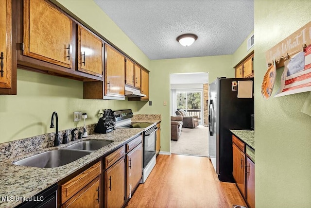 221 Highpoint Dr, Diamondhead, MS 39525 - kitchen with stainless steel fridge, a textured ceiling, white range with electric stovetop, sink, and light hardwood / wood-style floors