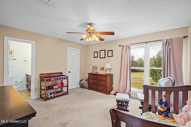 221 Highpoint Dr, Diamondhead, MS 39525 - bedroom with ceiling fan, light colored carpet, a textured ceiling, and ensuite bath