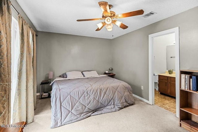 221 Highpoint Dr, Diamondhead, MS 39525 - bedroom with a textured ceiling, ceiling fan, light colored carpet, and ensuite bathroom
