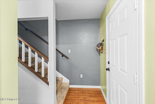 221 Highpoint Dr, Diamondhead, MS 39525 - stairs with wood-type flooring and a textured ceiling