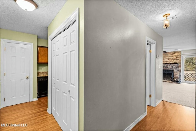 221 Highpoint Dr, Diamondhead, MS 39525 - hall with light hardwood / wood-style flooring and a textured ceiling