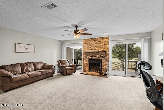 221 Highpoint Dr, Diamondhead, MS 39525 - carpeted living room with ceiling fan, a fireplace, and a textured ceiling