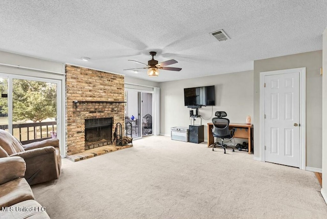 221 Highpoint Dr, Diamondhead, MS 39525 - living room with carpet flooring, ceiling fan, a fireplace, and a textured ceiling