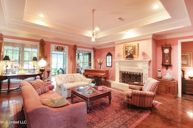 living room featuring a notable chandelier, ornamental molding, a tray ceiling, and tile patterned floors