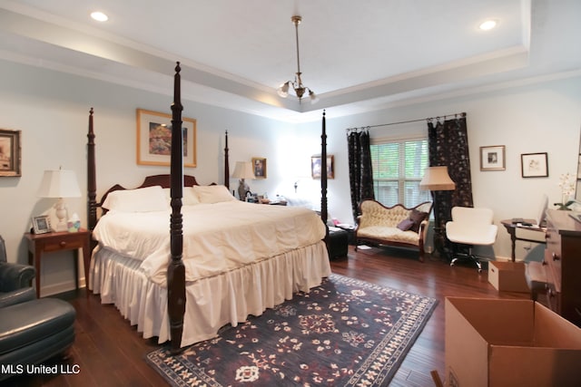 bedroom featuring crown molding, a chandelier, a tray ceiling, and dark hardwood / wood-style flooring