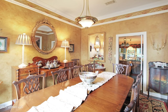 dining space featuring crown molding