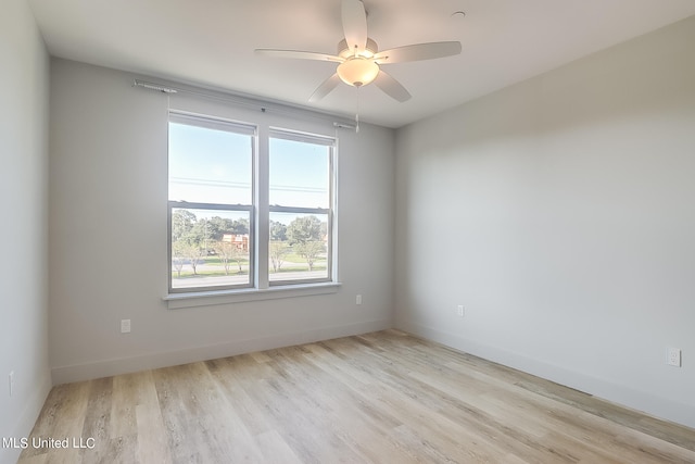 spare room featuring light hardwood / wood-style floors and ceiling fan