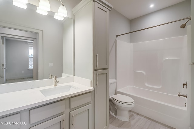 full bathroom with vanity, toilet, and  shower combination