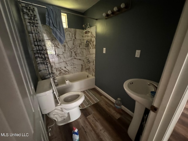 bathroom featuring toilet, hardwood / wood-style flooring, and shower / bath combo with shower curtain