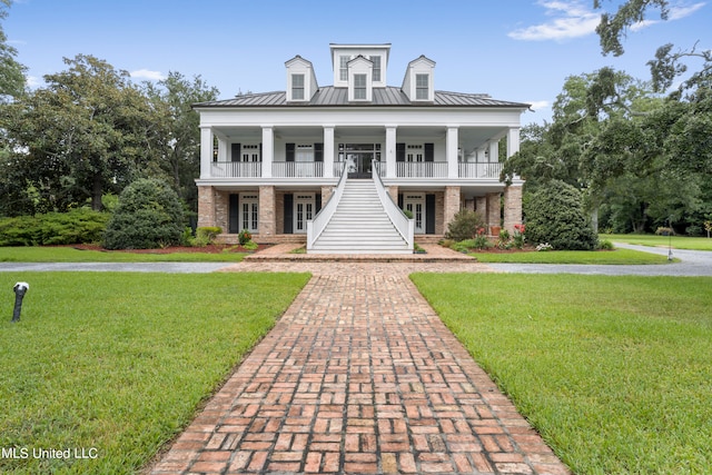 greek revival house featuring a front lawn and a porch