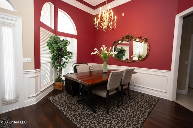 dining area with hardwood / wood-style floors, an inviting chandelier, and ornamental molding