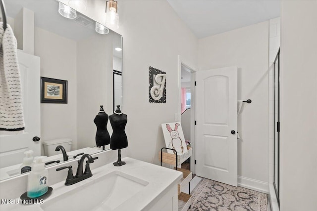 bathroom with a stall shower and vanity