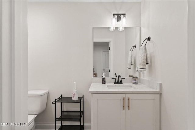 bathroom featuring toilet and vanity