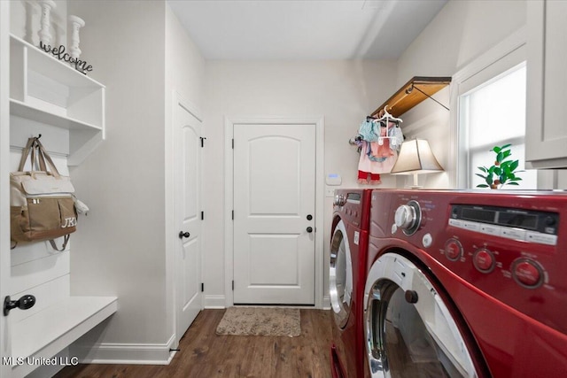 washroom with baseboards, separate washer and dryer, laundry area, and dark wood-style floors