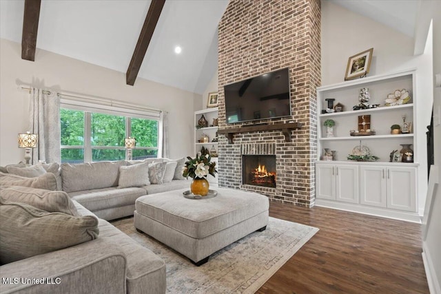 living area featuring beam ceiling, wood finished floors, high vaulted ceiling, built in features, and a brick fireplace