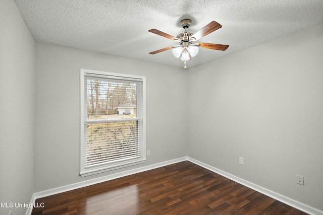 empty room with ceiling fan, a textured ceiling, and dark hardwood / wood-style flooring