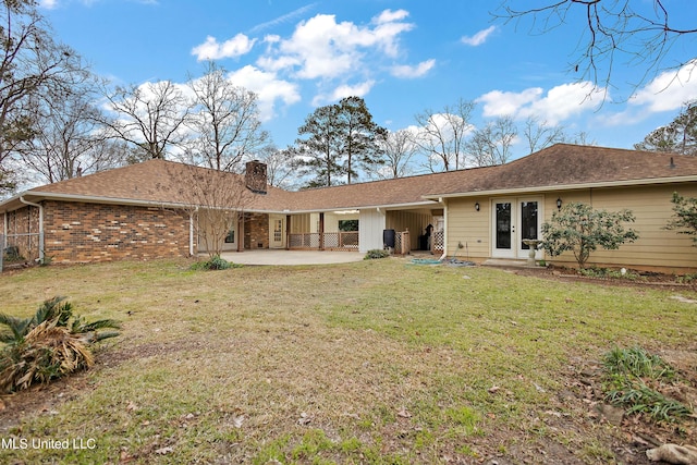 back of house with french doors, a patio, and a yard