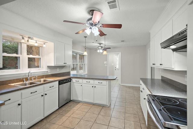 kitchen featuring kitchen peninsula, a textured ceiling, stainless steel appliances, and white cabinetry