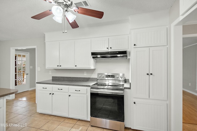 kitchen with a textured ceiling, white cabinetry, ceiling fan, light tile patterned floors, and stainless steel electric range