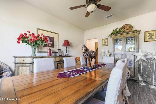 dining area with ceiling fan, visible vents, and wood finished floors