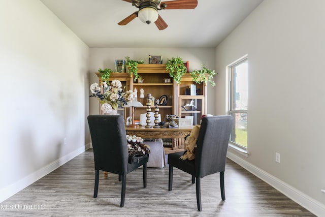 office area with baseboards, a ceiling fan, and wood finished floors