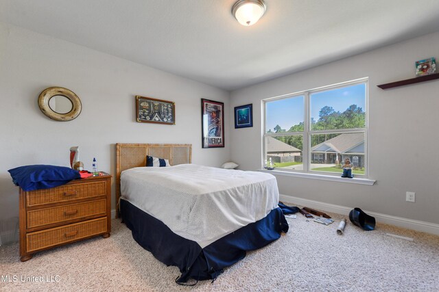 bedroom with carpet and baseboards