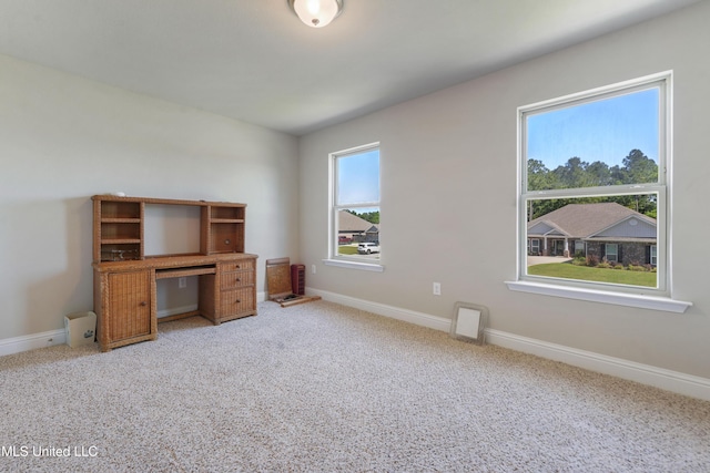 unfurnished office with baseboards and light carpet