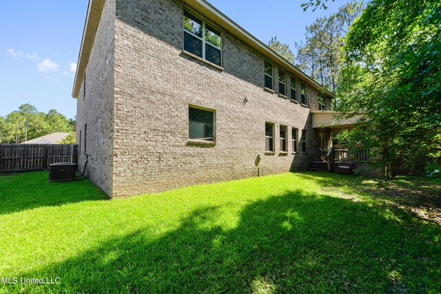 8448 Rock Glen Rd, Biloxi, MS 39532 - rear view of house featuring a yard, fence, and brick siding