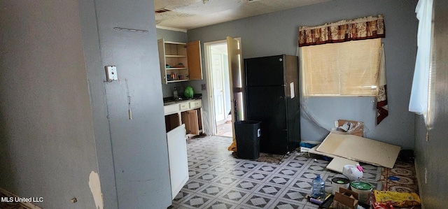 kitchen featuring black refrigerator