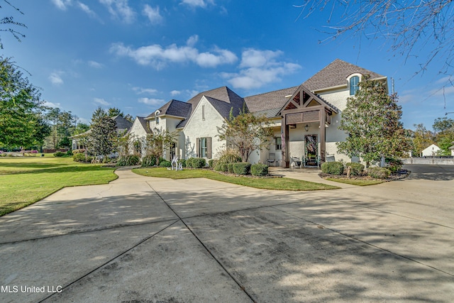 french country home with a front lawn