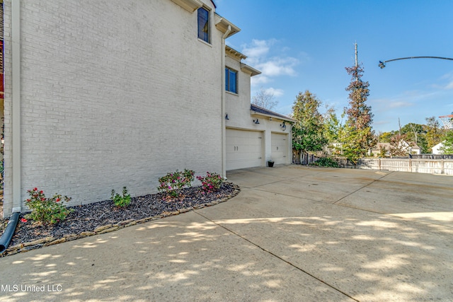 view of side of home featuring a garage