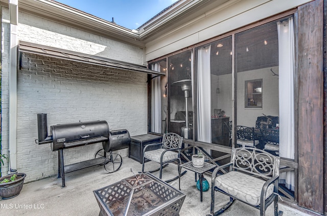 view of patio / terrace featuring grilling area and a fire pit