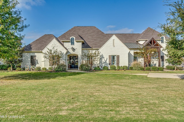 french provincial home with a front yard