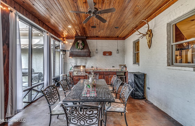 sunroom / solarium featuring ceiling fan and wood ceiling